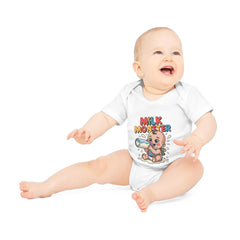 Baby wearing a white onesie with 'Milk Monster' design on a white background