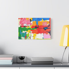 Colorful abstract painting on a wall above a shelf with books and a lamp.