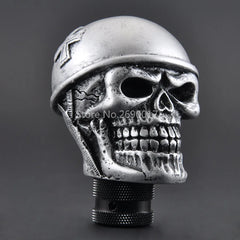 Skull-shaped gear shift knob with military helmet on a dark background