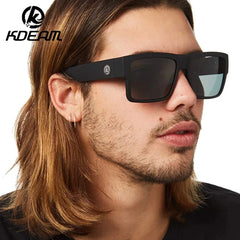 Man wearing black sunglasses with a neutral background, featuring the KDEAM brand.