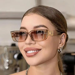 Woman wearing large sunglasses with a blurred background